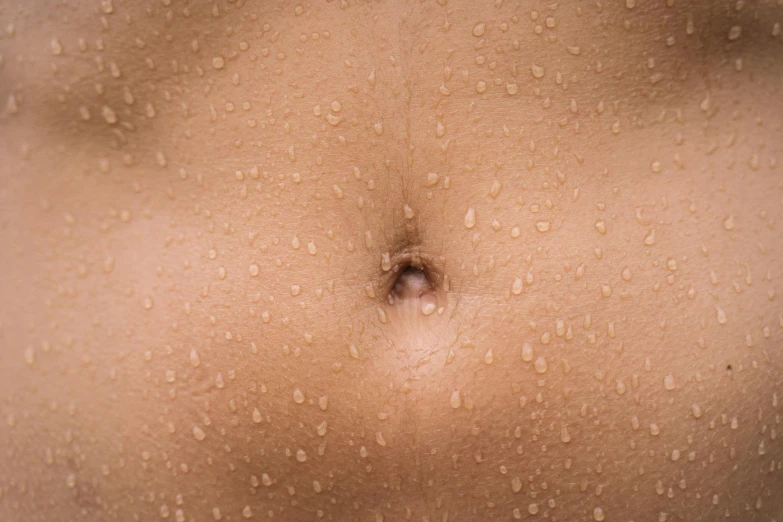 a close up of a person's stomach with water droplets on it, light tan, hydration, exposed midriff, manuka
