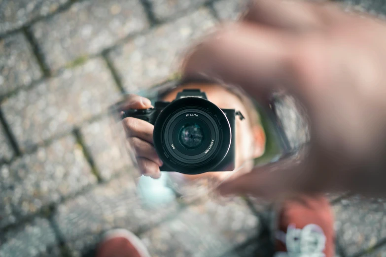 a person taking a picture with a camera, a picture, by Niko Henrichon, pexels contest winner, reflective lens, pov camera looking into the maw, sony a 6 3 0 0, unsplash 4k