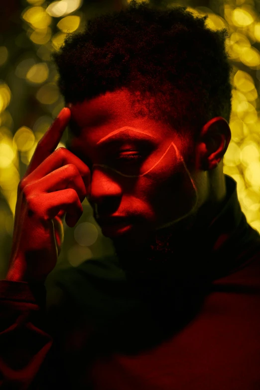 a close up of a person talking on a cell phone, an album cover, by Maxwell Bates, trending on pexels, red glowing skin, thinker pose, golden light, black teenage boy