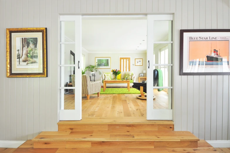 an open door leading to a living room, inspired by Michael Ancher, pexels contest winner, light and space, oiled hardwood floors, above the family room, videogame still, better homes and gardens