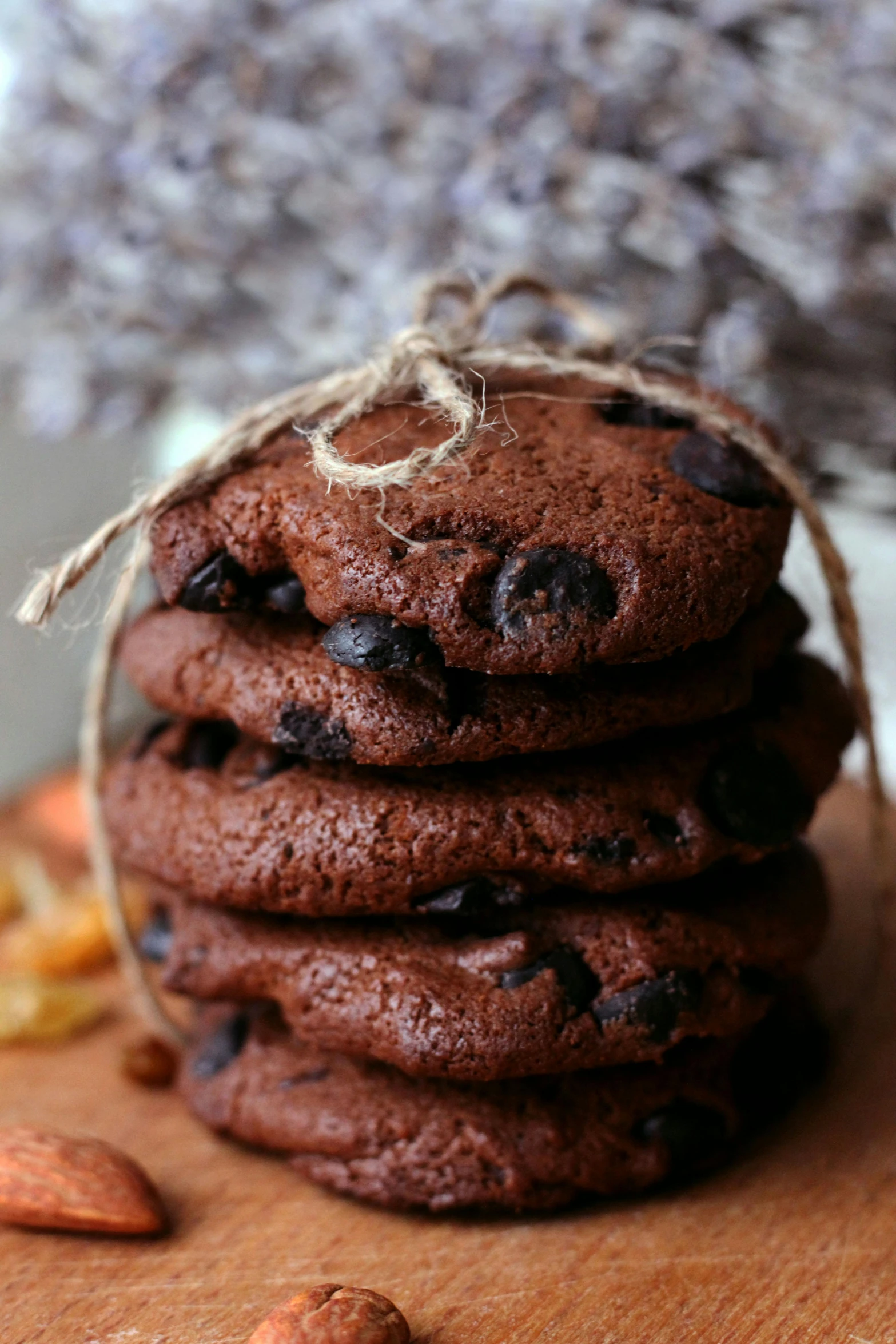 a stack of chocolate cookies sitting on top of a wooden cutting board, a portrait, pexels, with a soft, adorable, oh