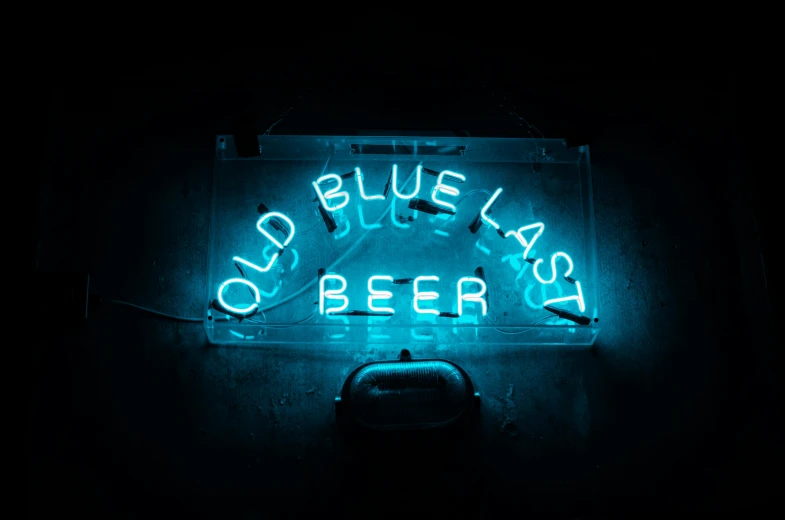 a neon sign is lit up in the dark, inspired by Elsa Bleda, unsplash contest winner, cold beer, ((blue)), old west, aged 2 5