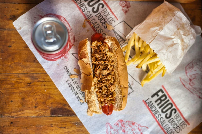 a hot dog and french fries on a table, red meat shreds, underground, brutus, press shot