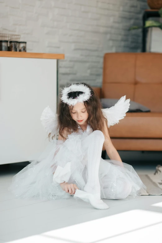 a little girl dressed as an angel sitting on the floor, pexels contest winner, teen girl, 15081959 21121991 01012000 4k, full body with costume, trending on