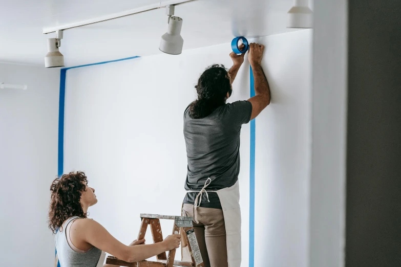 a couple of people that are painting a wall, a hyperrealistic painting, by Everett Warner, pexels contest winner, temporary art, thick blue lines, interior white wall, background image, electrical wiring!