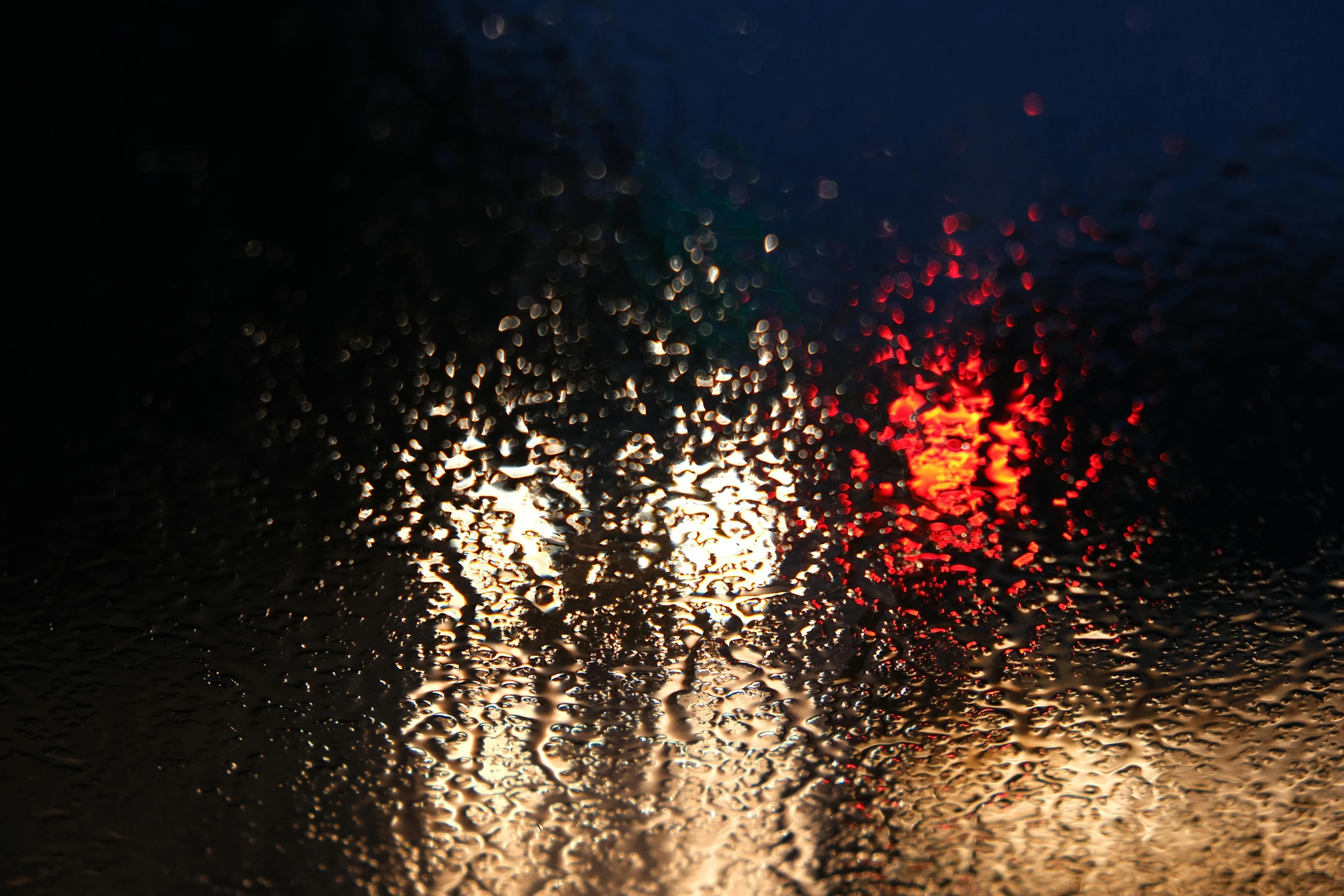 a blurry picture of a street at night, a picture, unsplash, hurufiyya, water droplets, late afternoon sun, red rain, reflection