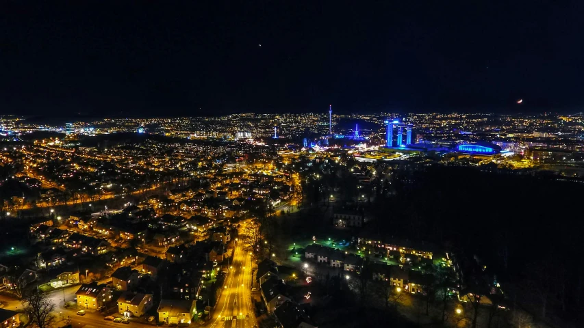 an aerial view of a city at night, by Sebastian Spreng, pexels contest winner, hurufiyya, munich, high blue lights, view from the side, high quality photo