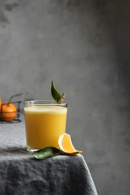 a glass of orange juice sitting on top of a table, renaissance, grey mist, square, shot on sony a 7, thumbnail