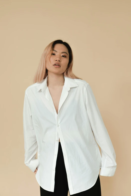 a woman wearing a white shirt and black pants, an album cover, inspired by Ruth Jên, trending on unsplash, wearing a white button up shirt, detailed product image, white wrinkled shirt, asian descent