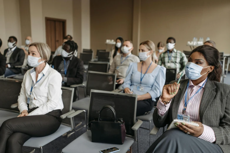 a group of people sitting in chairs with masks on, a photo, standing in class, avatar image, high quality image, professional image