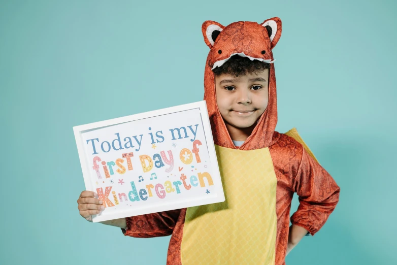 a young boy holding a sign that says today is my first day of kindergarten, an album cover, by Elsie Henderson, pexels contest winner, an anthropomorphic fox, studio shoot, fancy dress, official print