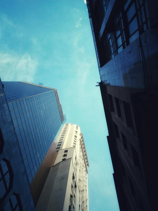 a couple of tall buildings next to each other, an album cover, unsplash, worm\'s eye view, low quality photo, são paulo, multiple stories