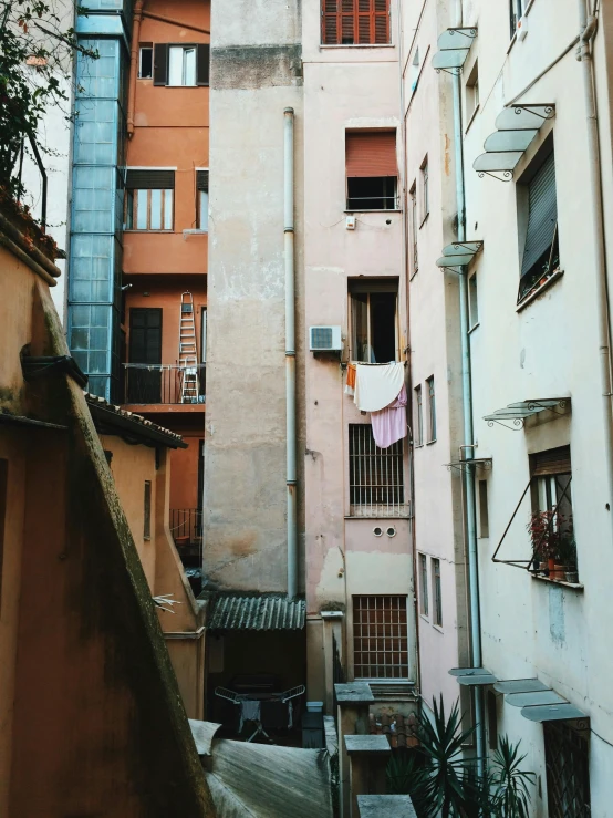 a couple of buildings that are next to each other, inspired by Elsa Bleda, pexels contest winner, young handsome pale roma, hidden area, low quality photo, apartment