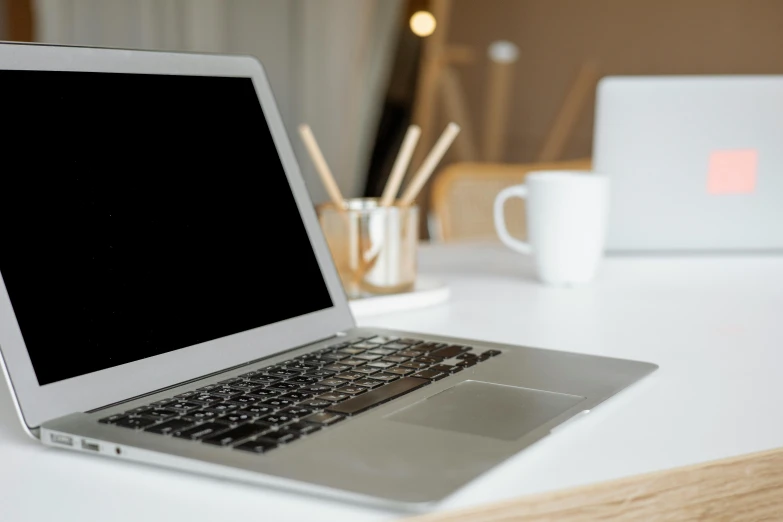 a laptop computer sitting on top of a white desk, by Tom Bonson, glowing accents, close up image, diy, no - text no - logo