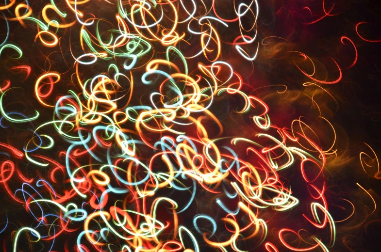 a close up of a christmas tree with many lights, inspired by Bruce Munro, pexels, abstract expressionism, swirles, red and yellow light, instagram post, neon electronic signs