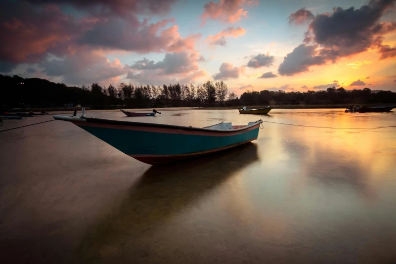 a blue boat sitting on top of a sandy beach, a picture, by Basuki Abdullah, unsplash contest winner, sunset + hdri, 3 boat in river, glossy surface, multicoloured