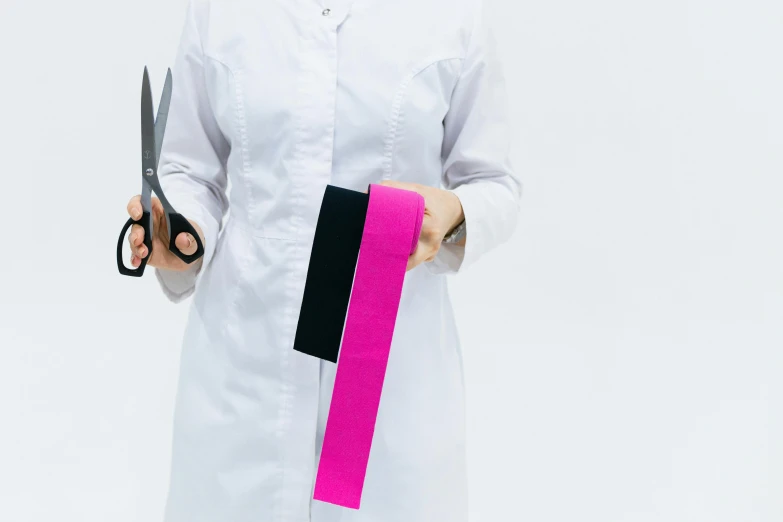 a woman in a lab coat holding a pair of scissors, pexels contest winner, hot pink and black, obi strip, solid colours material, set against a white background