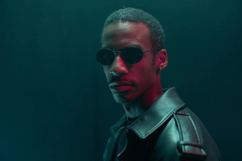 a man in a leather jacket and sunglasses, an album cover, inspired by Terrell James, trending on pexels, photorealism, altered carbon series, playboi carti portrait, underexposed, movie still 8 k