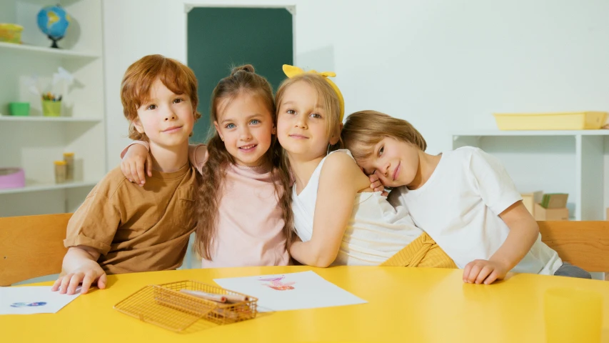 a group of children sitting at a table, a picture, pexels contest winner, yellow clothes, 15081959 21121991 01012000 4k, looking her shoulder, iq 4