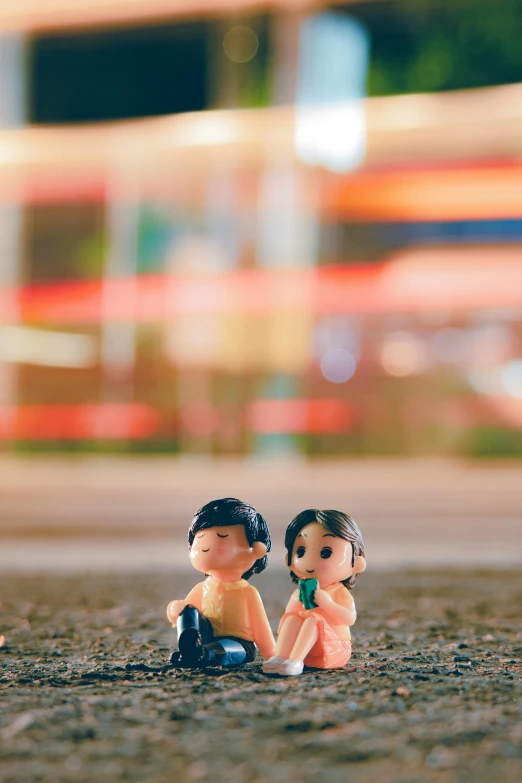 a couple of figurines sitting next to each other, a picture, pexels contest winner, road trip, asian, summer evening, kids toys