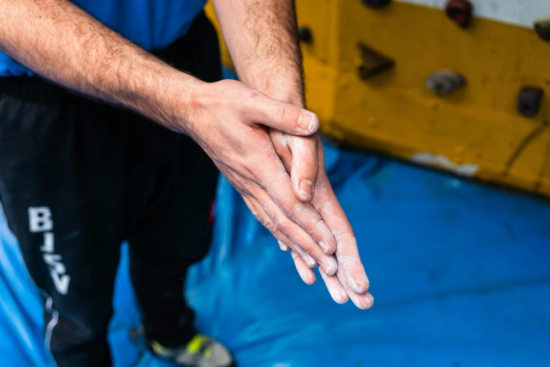 a close up of a person washing their hands, by Niko Henrichon, ninja warrior, in a gym, manuka, open palm