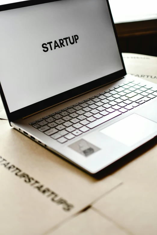 a laptop computer sitting on top of a table, by Carey Morris, trending on unsplash, ai startup, small manufacture, starlit, high angle close up shot