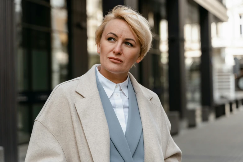 a woman standing on a sidewalk in front of a building, pexels contest winner, wearing wool suit, wearing a white button up shirt, olga zakharova, 15081959 21121991 01012000 4k