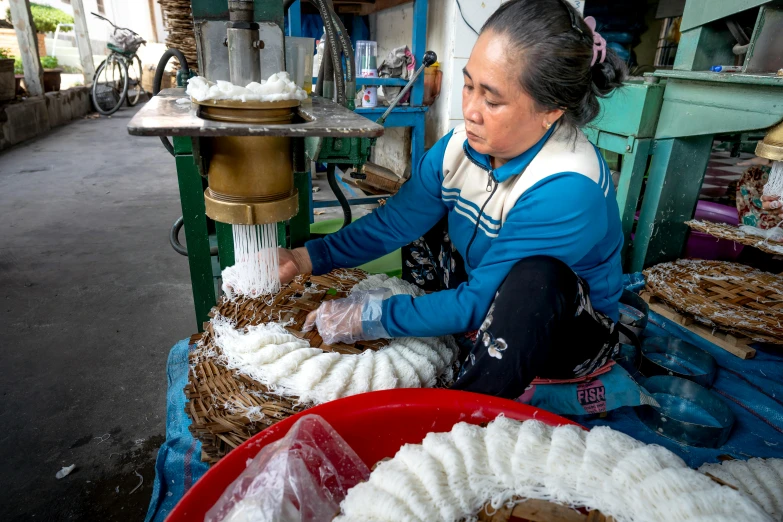 a woman sitting at a table filled with lots of food, process art, sheep wool, in style of lam manh, carved soap, avatar image