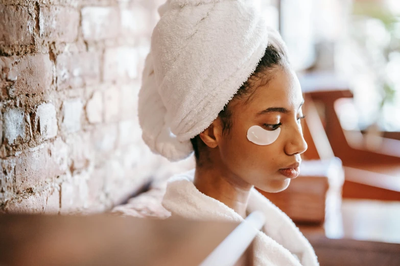 a woman with a towel wrapped around her head, trending on pexels, eyepatches, manuka, relaxed eyebrows, 1 2 9 7