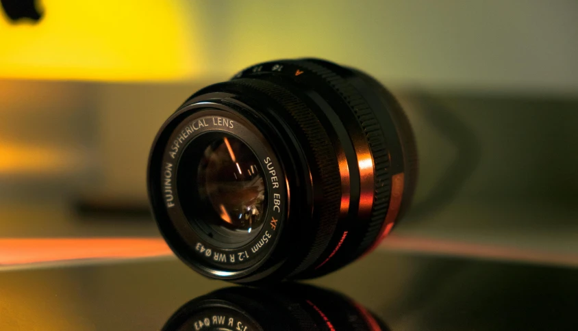 a close up of a camera lens on a table, by Thomas Häfner, unsplash, photorealism, fujifilm x - pro 2, sharper luminescent focus, medium format. soft light, leica summicron-t 23 mm f/2