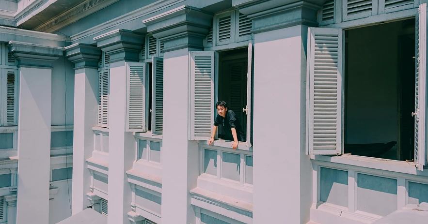 a man that is looking out of a window, set on singaporean aesthetic, neo classical architecture, instagram picture, fan favorite