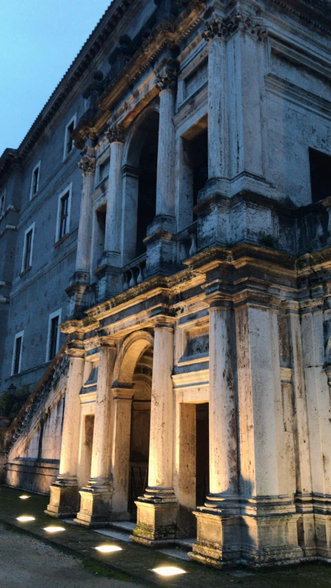 an old building is lit up at night, inspired by Hubert Robert, romanesque, low quality photo, album cover, naples, profile image