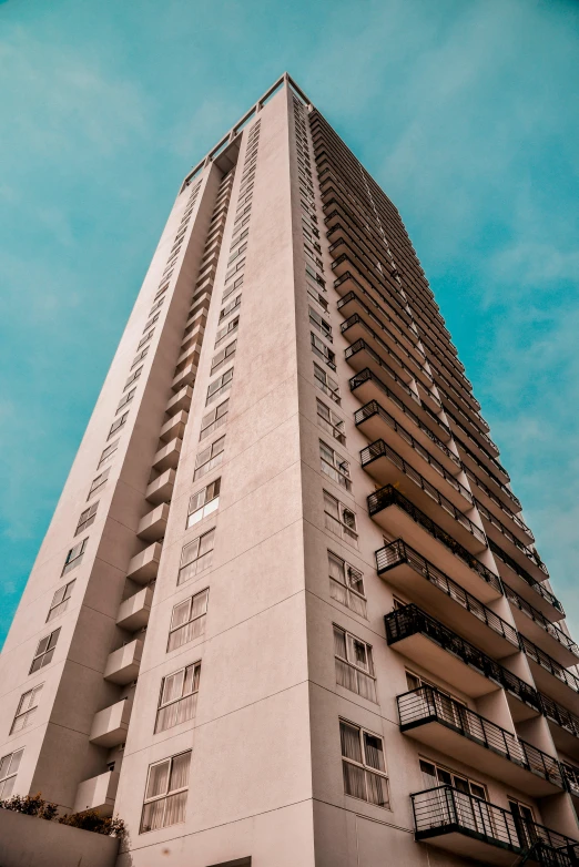 a tall building with balconies on top of it, by Lee Loughridge, unsplash, vhs colour photography, 8k photo, brown, towering