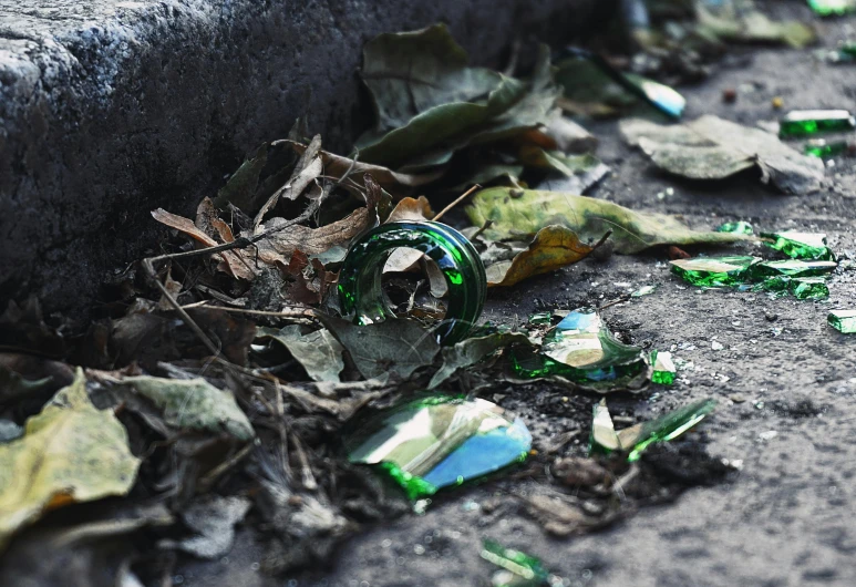 a pile of broken glass sitting on the side of a road, pexels contest winner, environmental art, green tiara, instagram photo, urban surroundings, promo image
