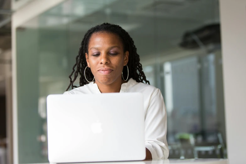 a woman sitting in front of a laptop computer, by Carey Morris, pexels contest winner, black female, official screenshot, shallow depth, multiple stories