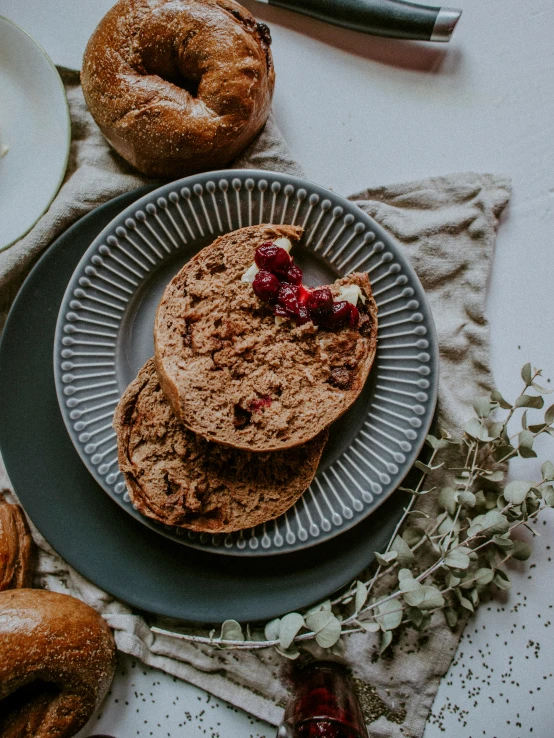 a close up of a plate of food on a table, breads, red brown and grey color scheme, thumbnail, jovana rikalo