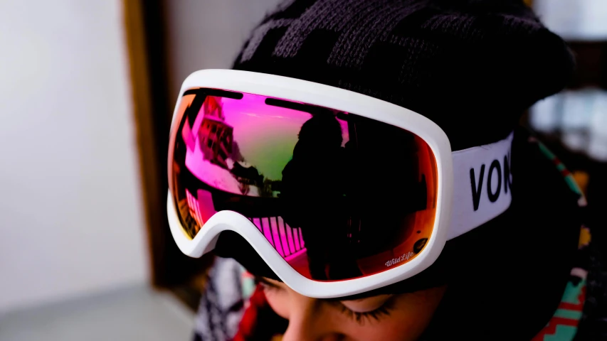 a close up of a person wearing a pair of ski goggles, by Julia Pishtar, white and pink, kids, reflect, vibrant scene