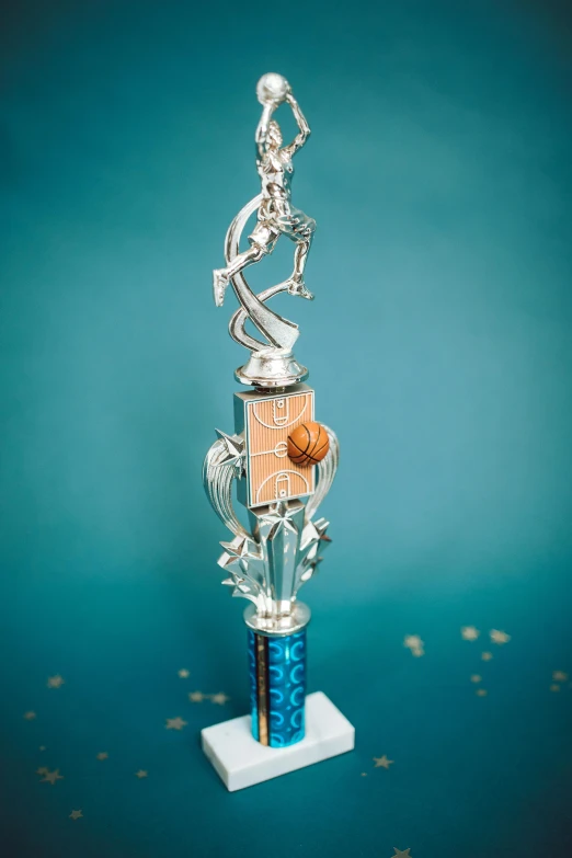 a silver trophy sitting on top of a blue table, dribble contest winner, top down shot, chrome dance pole, from then on a basketball, intricate accurate details