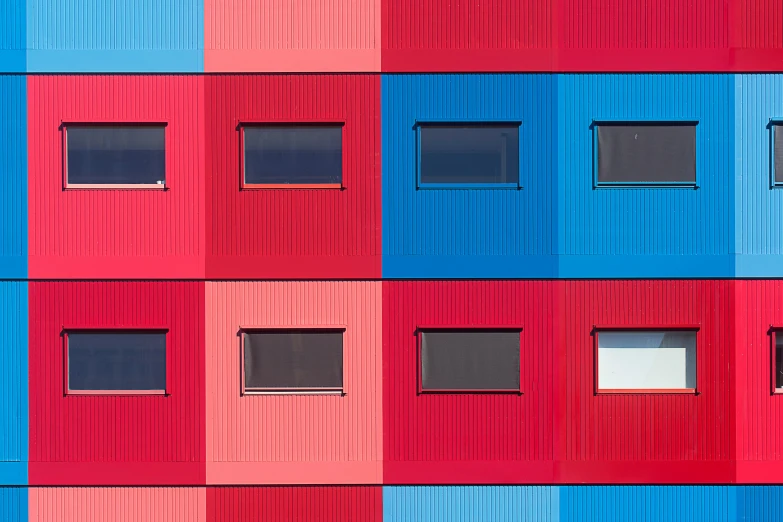 a multicolored building with lots of windows, inspired by Donald Judd, pexels contest winner, modular constructivism, red and blue, scandinavian, minimalist photorealist, square shapes