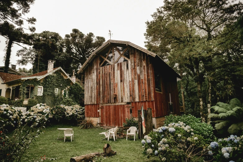 a red barn sitting on top of a lush green field, pexels contest winner, renaissance, beachwood treehouse, wedding, reclaimed lumber, with a french garden