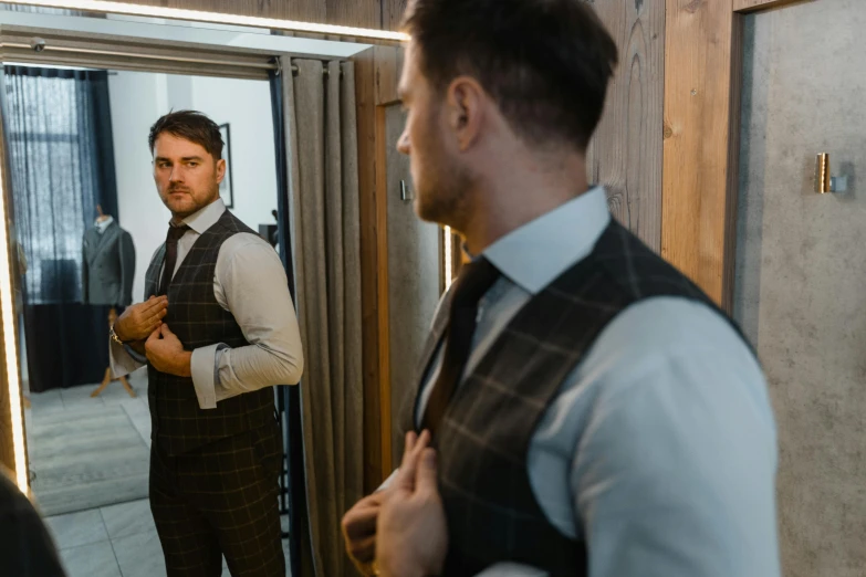 a man adjusting his tie in front of a mirror, a screenshot, pexels contest winner, liam brazier, wearing a waistcoat, full body focus, looking from behind