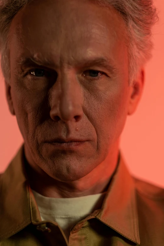 a close up of a person wearing a shirt, a character portrait, inspired by John Cale, unsplash, photorealism, orange and red lighting, jean luc picard, collateral, jim jarmusch