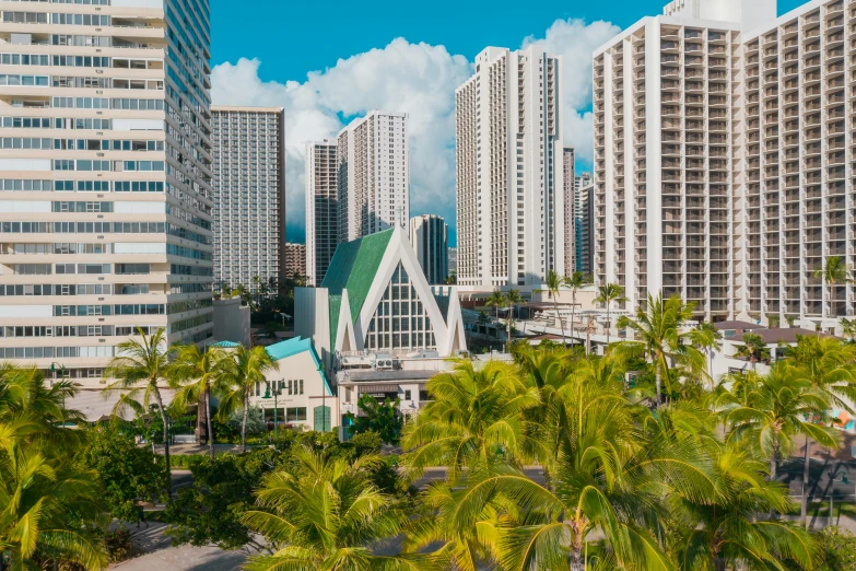 a view of a city with tall buildings and palm trees, hawaii beach, white marble buildings, a cathedral under an overpass, evan lee