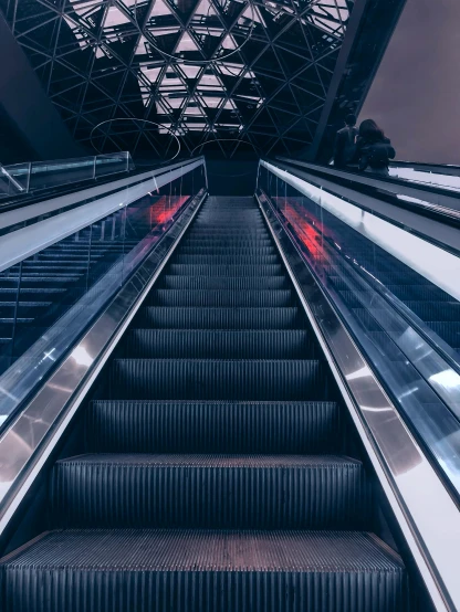 a close up of an escalator in a building