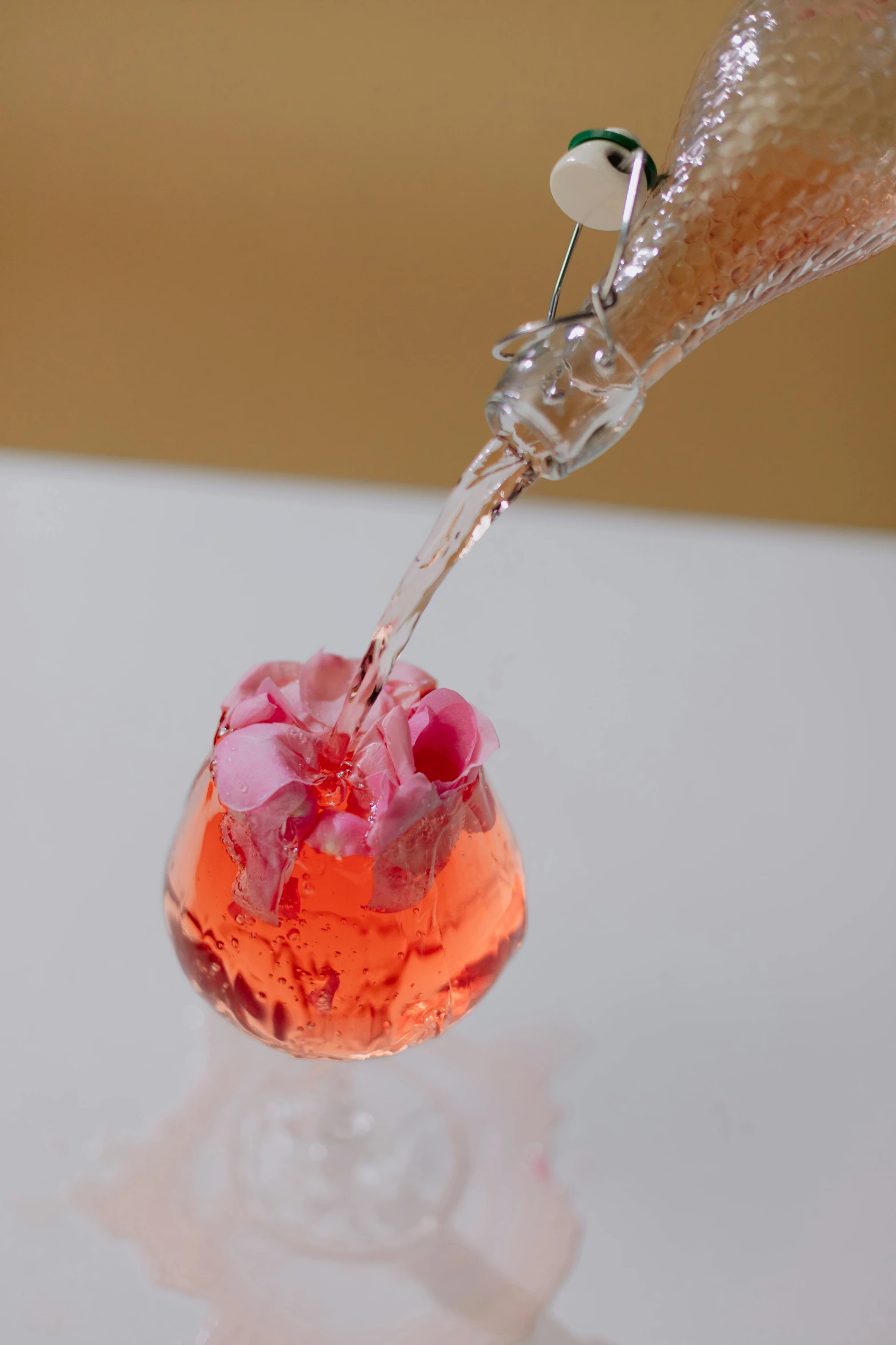 a glass filled with liquid sitting on top of a table, inspired by Jacopo Bellini, process art, lush sakura, pouring, candy treatments, high angle close up shot