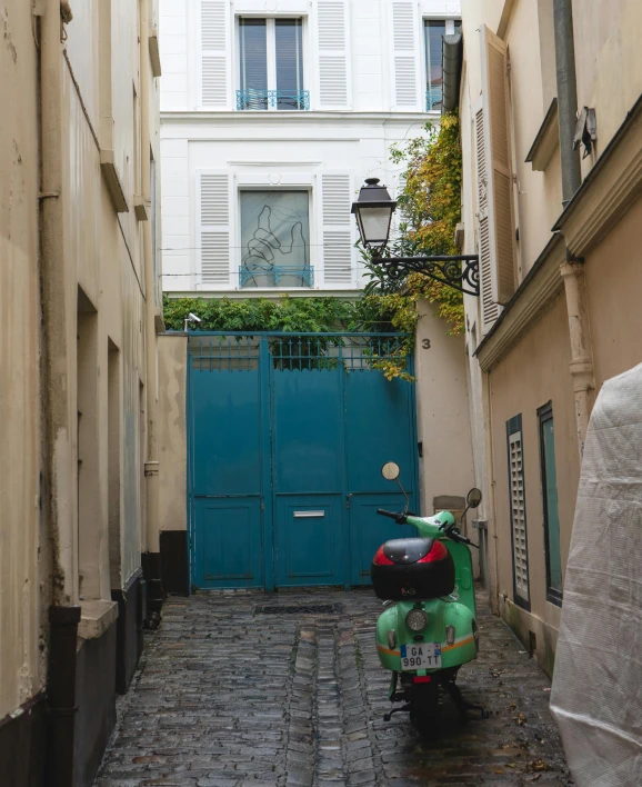 a scooter is parked on a cobblestone street, trending on unsplash, paris school, small path up to door, teal color graded, square, illegible