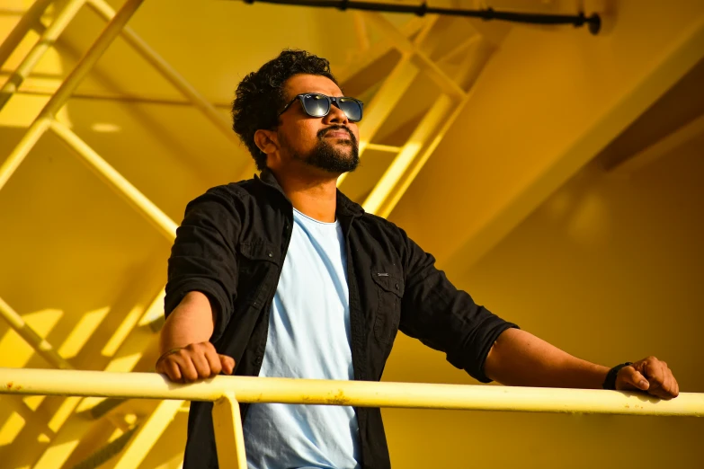 a man standing in front of a yellow wall, by Max Dauthendey, pexels contest winner, lyco art, standing on a ship deck, square, shaggy, profile pose