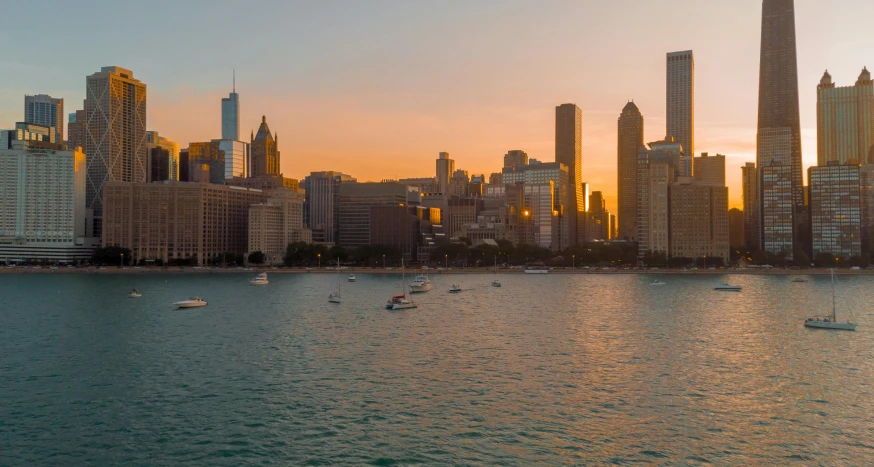 a large body of water with a city in the background, by Emanuel Witz, pexels contest winner, chicago skyline, sunset panorama, gigapixel photo, golden hour light