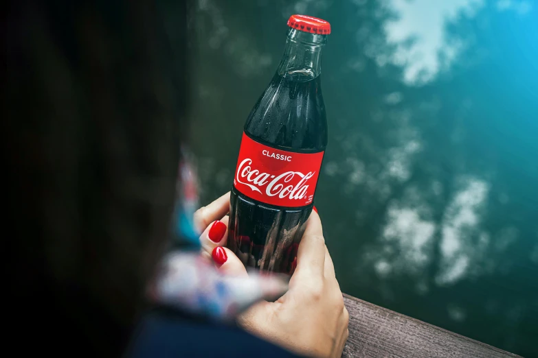 a woman holding a bottle of coca cola, pexels contest winner, 🦩🪐🐞👩🏻🦳, high quality product photo, al fresco, 2263539546]