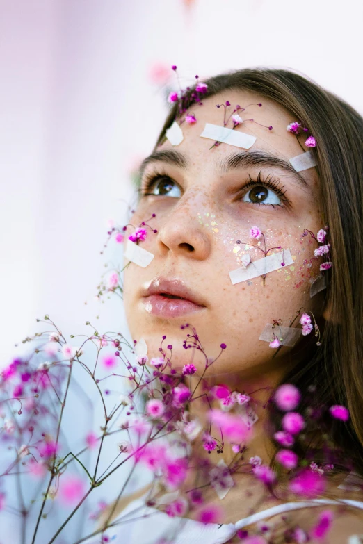 a woman with flowers all over her face, trending on pexels, portrait of teenage girl, ribbons and flowers, manuka, skin made of led point lights